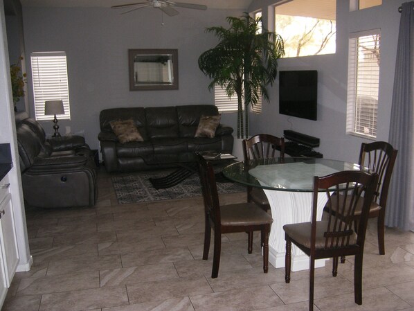 Open living area with reclining sofas and smart TV