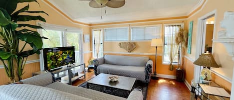 Living room. Balcony on left.  Bright and cheerful. Lots of natural light!