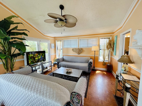 Living room. Balcony on left.  Bright and cheerful. Lots of natural light!