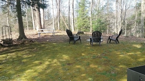 fire pit area with lounger chairs to relax by the fire