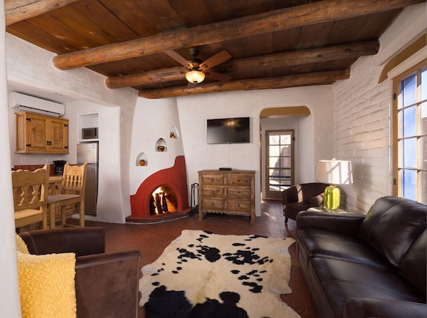 Classic Santa Fe living room with traditional vigas and an authentic kiva fireplace
