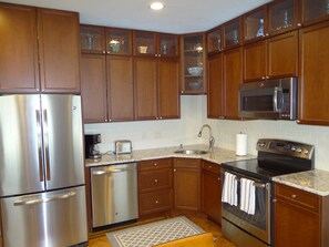 Eat in kitchen with cherry cabinets and granite counters