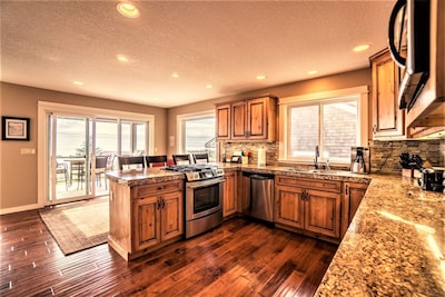 Open kitchen w/easy access to deck with grill and incredible views as you cook!