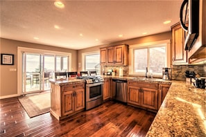 Open kitchen w/easy access to deck with grill and incredible views as you cook!