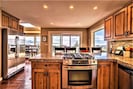 Chef's kitchen w/ stainless steel appliances, granite counters & large pantry