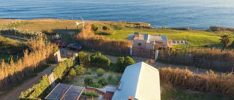 Aerial view of the house with the white roof, Africa in background