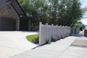 180 Degree Drive Thru.  Night Lights and Property's Number are on top our fence.