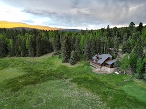 Birds-eye view of the house from the valley behind