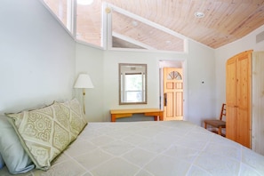 Peaceful bedroom has pocket door to close off from the rest of the cottage.