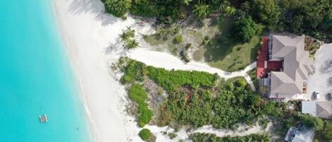 Aerial shot showing direct beachfront location