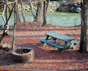 Wintertime view of the Chattahoochee River, picnic table and fire pit.