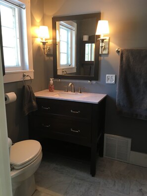 Full bathroom attached to first floor bedroom - shower is to the right of photo