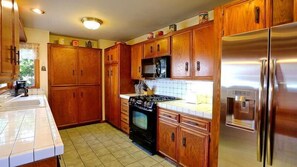 Well equipped kitchen for six. Gas BBQ on patio and pass through window to patio