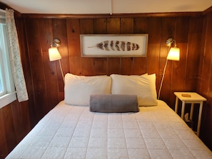 The cottage's cozy bedroom with queen-sized bed