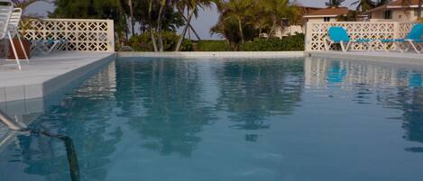 THE COOLING POOL AT ISLAND PARADISE BEACH VILLAGE WITH PLENTY OF SUN-BEDS   