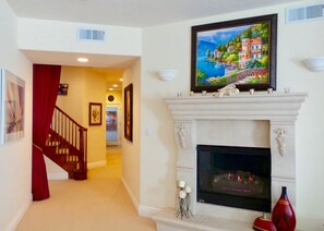 Family Room with fireplace leading to bedrooms