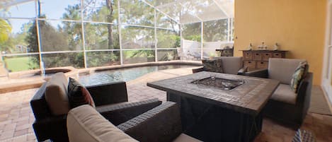 Pool area lounge with outside TV and great golf course view.