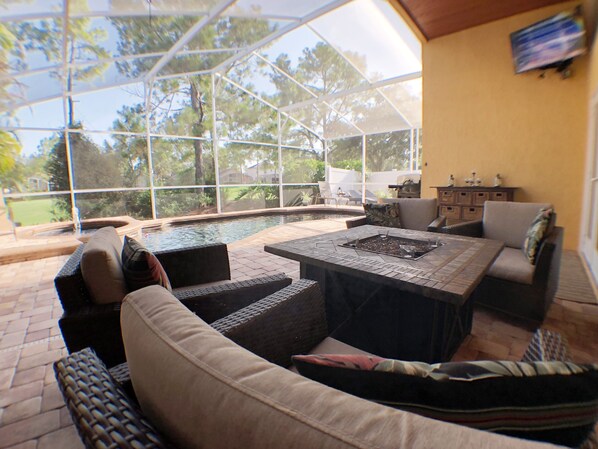 Pool area lounge with outside TV and great golf course view.