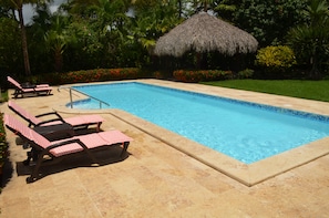 LARGE PRIVATE POOL WITH PLENTY OF LOUNGE CHAIRS.