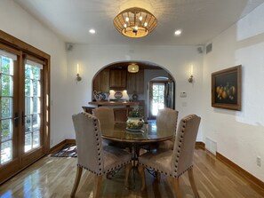 The dining area w/ leather chairs. Set a beautiful table w/ all accouterments. 