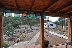 flag-lined porch looking out on xeriscaped garden