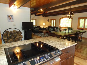 The kitchen is open to the living and dining area. TV swivels toward living room