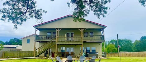 Rear of Barndo has fire pit, gas bbq, hot tub, rockers, and accent lighting.