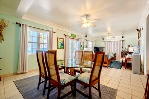 Dining area with view to living room; double doors to porch on left