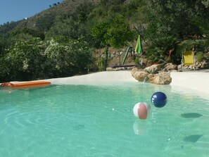 natural lake shaped panoramic pool in the middle of a large Mediterranean garden