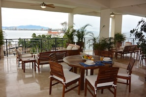 Your private balcony is set up with a sitting area and a dinning area.