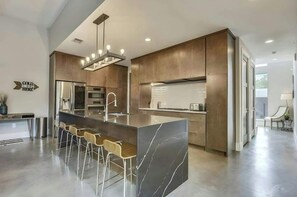 The gourmet chef’s kitchen features a large island with bar seating.