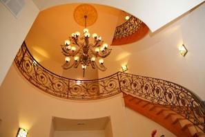 The custom spiral staircase ascends from the foyer to the 3rd floor.  
