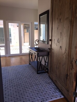 The entrance hall looks out toward the loggia.