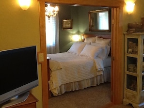 Another view of bedroom from living area with French doors open