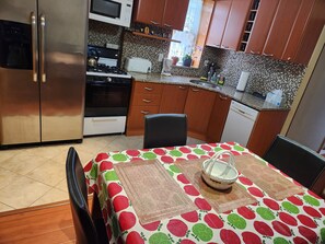 Shared  eat-in kitchen dining table with  chairs.