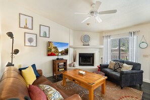 Relax in the open living room with leather couches and plenty of throw pillows