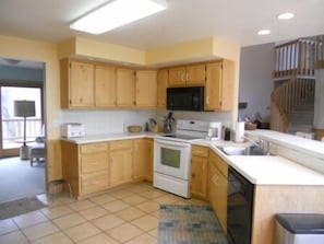 Kitchen Area with snack bar and all the cooking and serving supplies you need