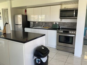 Kitchen with Full size cooker , Microwave and refrigerator, 