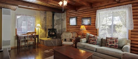 Beautiful living room with Tahoe Stone Hearth and original log walls.