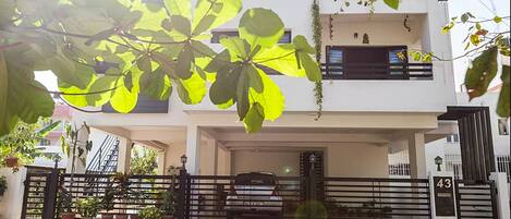 Elegantly designed Green house with a lush organic garden all around it.