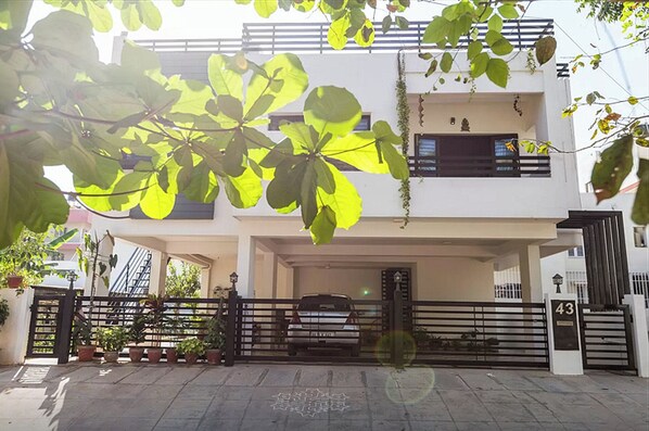 Elegantly designed Green house with a lush organic garden all around it.