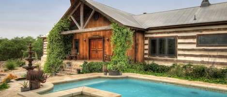 The exterior of The Lodge over looking the pool and hot tub