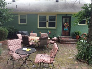 Shaded brick patio is outside the kitchen back door. Perfect for entertaining. 
