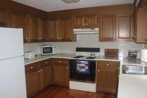 Kitchen with Electric Stove, Toaster, Toaster Oven, and Microwave