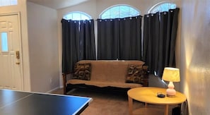 Entry, sitting room, and ping pong table