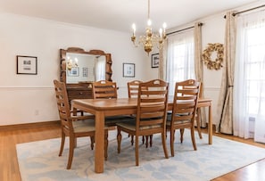 Set the table for a feast with friends/family in the beach-themed dining room.