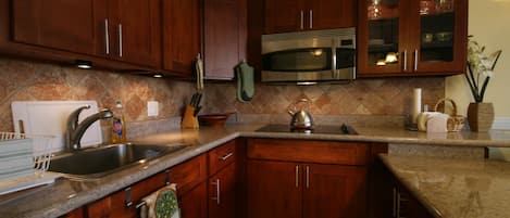 Completely renovated kitchen with cherry wood cabinets and granite countertops