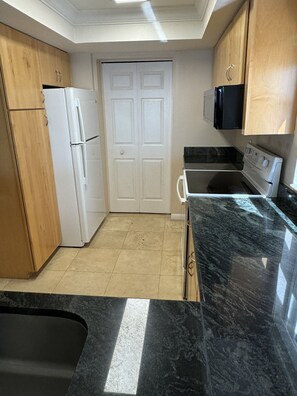 Open space with laundry room closed off from kitchen