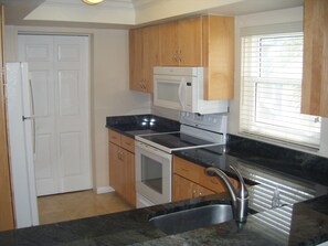 Large modern kitchen with window for open feel.