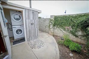 Outdoor free Laundry attached to the home. Outdoor shower is pictured also.